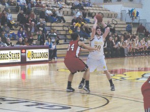 Bringing it Home: Junior Amy Joostberns (#30) gears up to make a pass at a recent game. After a long haul on the road, the Bulldogs will be bringing it back home this weekend for games against Northern Michigan and Michigan Tech. Photo By: Kristyn Sonnenberg | Photo Editor
