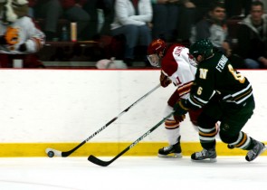 Guiding the Puck: Sophomore Jordie Johnston pulls away from a Norhern Michigan opponent at Wink Arena on Friday. The game ended with a 3-3 tie in overtime. Saturday’s loss brings the team to a 17-8-4 record for the season. Photo By: Kate Dupon | Photographer